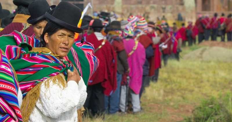 Crowds of mostly indigenous people wait in line to get into a ceremony for Bolivian President-elect Evo Morales where he was crowned as supreme chief of the Andean Indians at the archaeological site of Tiwanaku, 70 km from La Paz, on January 21, 2006, one day before his inauguration as Bolivia's first indigenous president. Morales, addressing thousands of Aymara and Quechua Indians at the ceremony, vowed to rewrite his country's constitution this year. Photographer: Diego Giudice/Bloomberg News