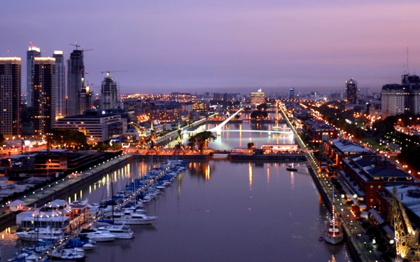 Puerto Madero neighborhood is seen  at dusk in Buenos Aires, Argentina, Friday, March 31, 2006. This year the government is expecting a  growth of around 9.6 percent of tourists arriving to Argentina, that would make more than 4 million tourists visiting the country. In 2005, earnings from tourism rose to US$3bn, or 11.7% more than in 2004. At center in white is the bridge "Puente de la Mujer". (AP Photo/Natacha Pisarenko)     
OPSE 2006ABR06 ARGENTINA TURISMO BUENOS AIRES VISTAS PANORAMICAS 
2006ABR06 AFD