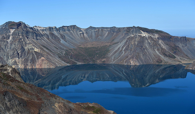 This general view shows Heaven Lake on the top of Mount Paektu on September 20, 2018 during a visit by North Korean leader Kim Jong Un and South Korean President Moon Jae-in. - Kim Jong Un and Moon Jae-in visited the spiritual birthplace of the Korean nation on September 20, for a show of unity after their North-South summit gave new momentum to Pyongyang's negotiations with Washington. (Photo by - / Pyeongyang Press Corps / AFP) / RESTRICTED TO EDITORIAL USE - MANDATORY CREDIT "AFP PHOTO / Pyeongyang Press Corps" - NO MARKETING NO ADVERTISING CAMPAIGNS - DISTRIBUTED AS A SERVICE TO CLIENTS