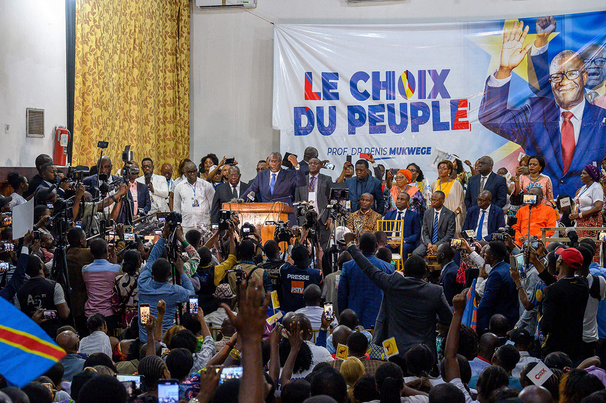 Denis Mukwege (c) addresses supporters in Kinshasa, on October 2, 2023. Dr Denis Mukwege, winner of the 2018 Nobel Peace Prize for his work on behalf of women victims of rape, announced on Monday in Kinshasa his candidacy for the presidential elections in the Democratic Republic of Congo in December. (Photo by Arsene Mpiana / AFP)